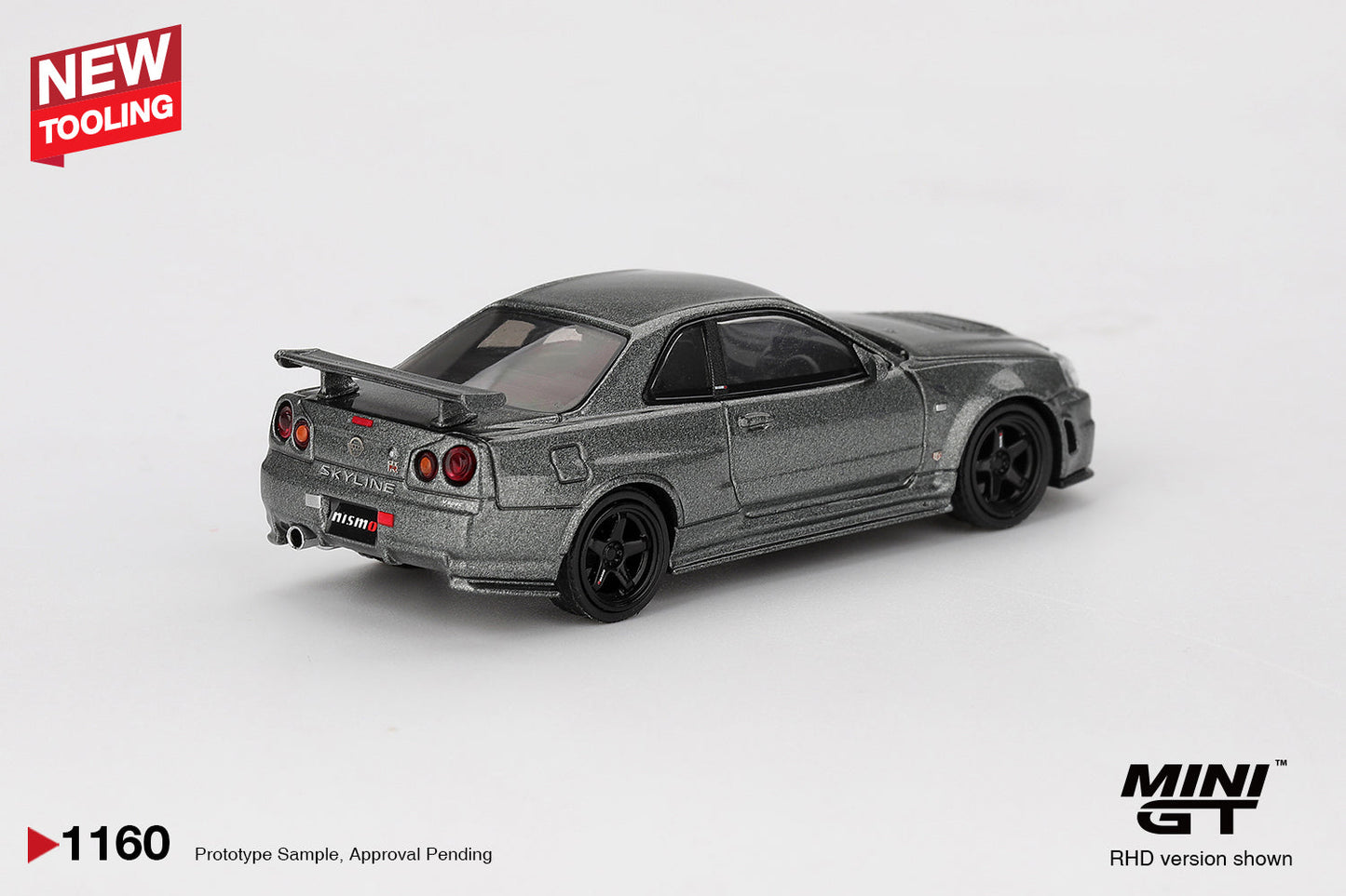 Mini GT - Nissan Skyline GT-R (R34) Dark Metal Gray Nismo CRS 1999 - Scala 1-64 MGT01160-BL Blister Packaging