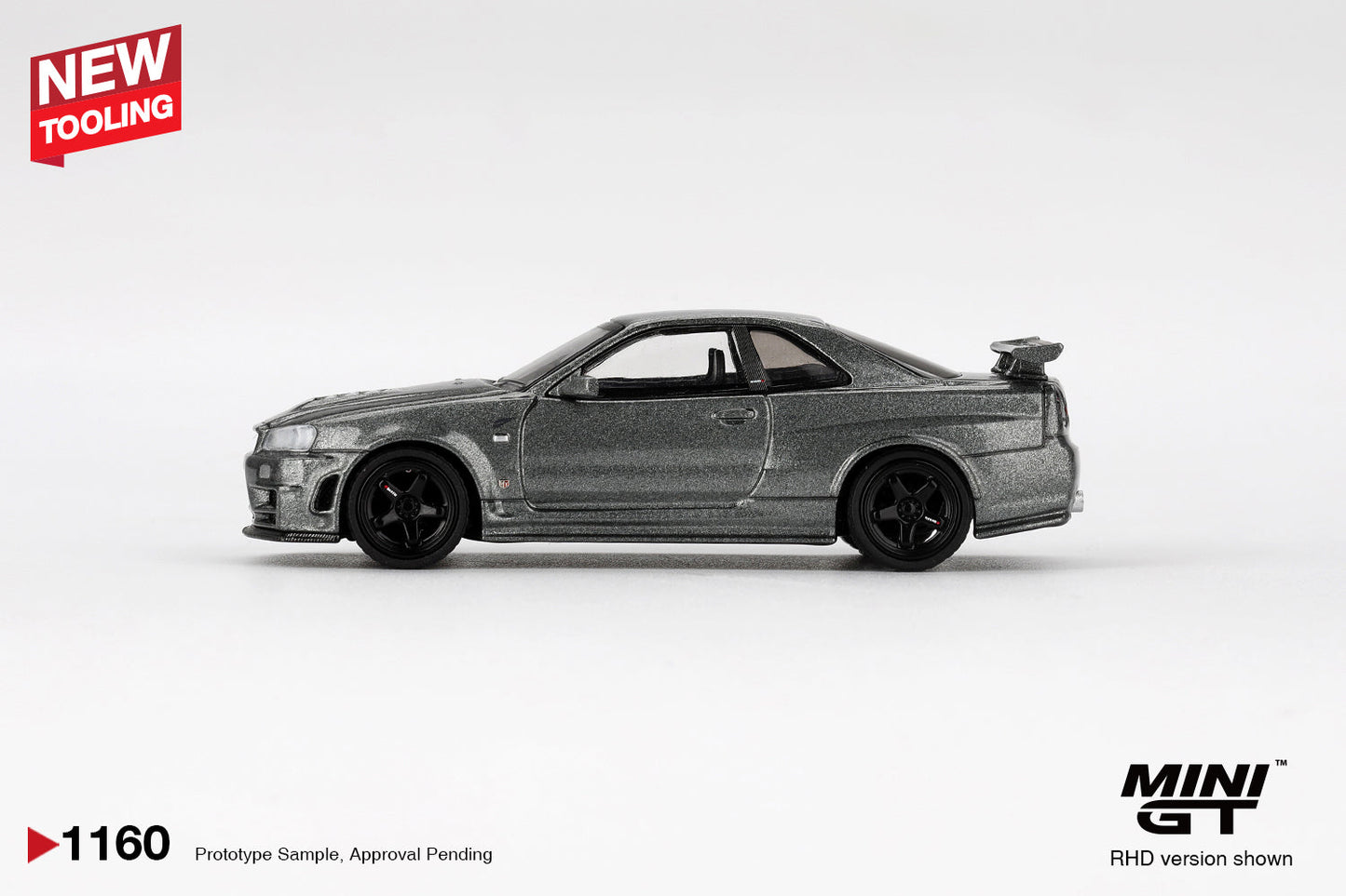 Mini GT - Nissan Skyline GT-R (R34) Dark Metal Gray Nismo CRS 1999 - Scala 1-64 MGT01160-BL Blister Packaging